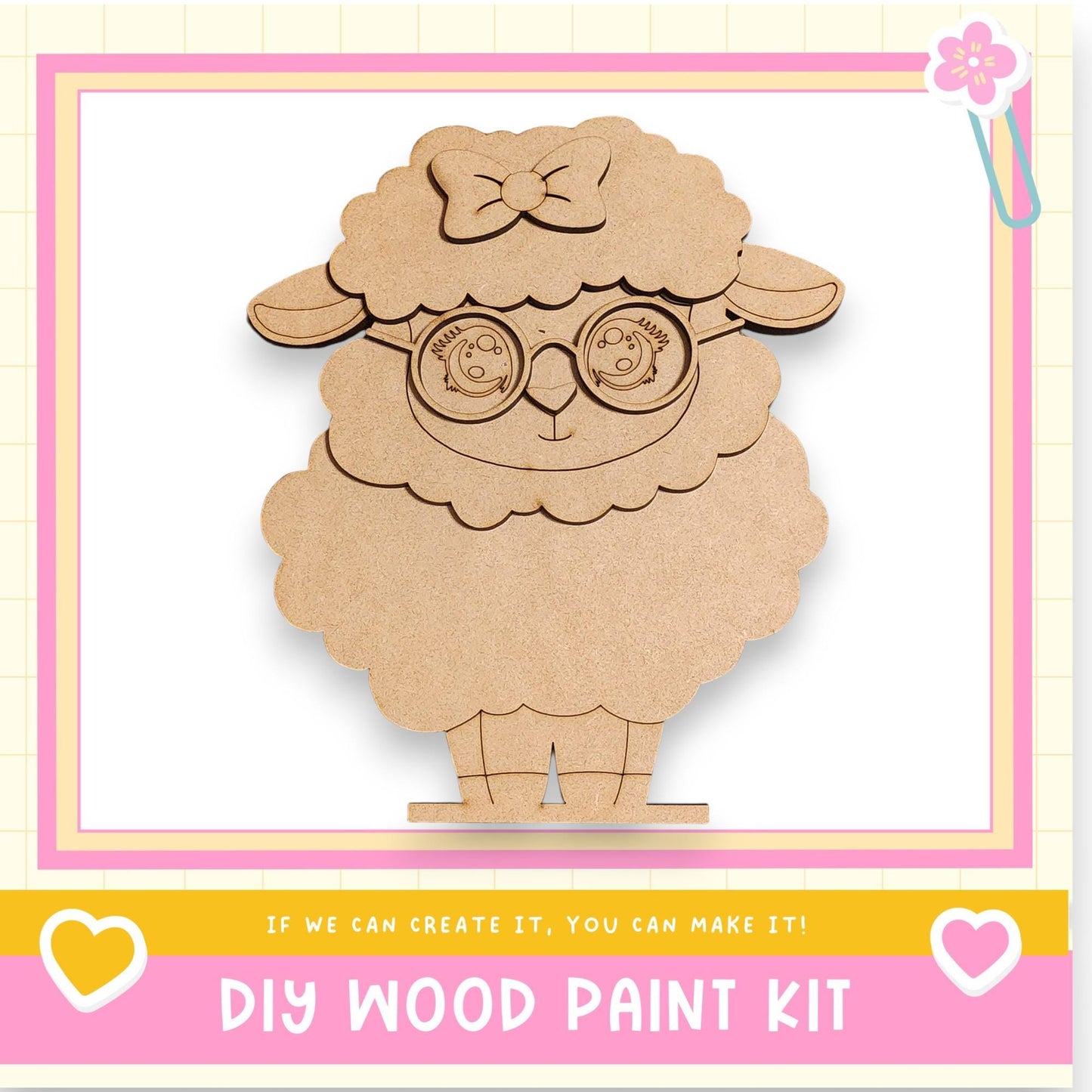 a wooden sheep-shaped object with a bow on its head, sitting on a pink and yellow background.