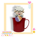 a red cup with a picture of a sheep sticking out of it