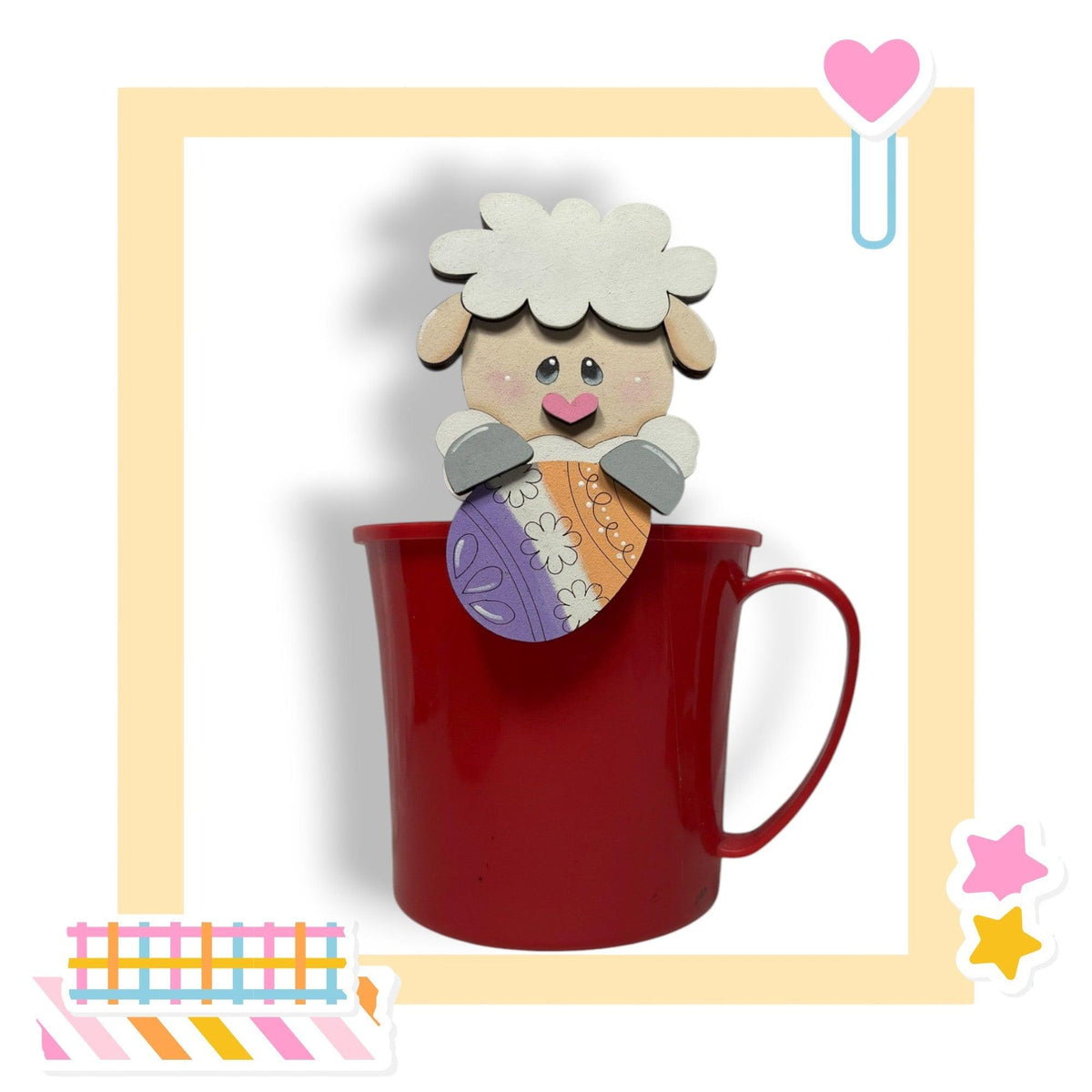 a red cup with a picture of a sheep sticking out of it