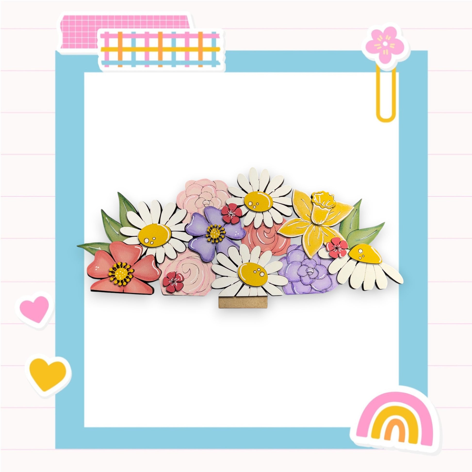 A colorful arrangement of various flowers, including daisies, roses, and lilies, set against a blue background with a pink and white checkered border.
