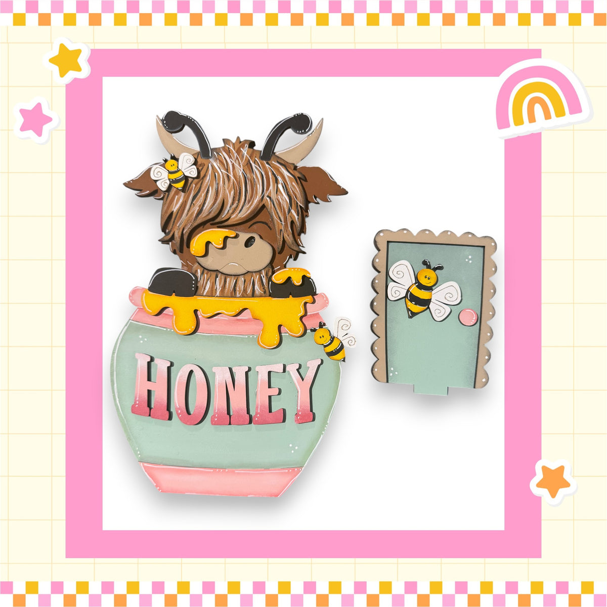 A cartoon image of a horned, furry animal with a honey pot on its back, surrounded by a pink and yellow border with stars and a rainbow.