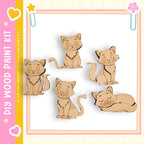 a collection of five wooden cat figurines, each with a unique pose, arranged in a row against a white background.