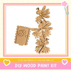 The image is a DIY wood paint kit featuring a wooden door and various wooden insects, such as dragonflies and bees, as well as a wooden flower. The kit appears to be made of wood and is designed for creating wooden decorations or art pieces.