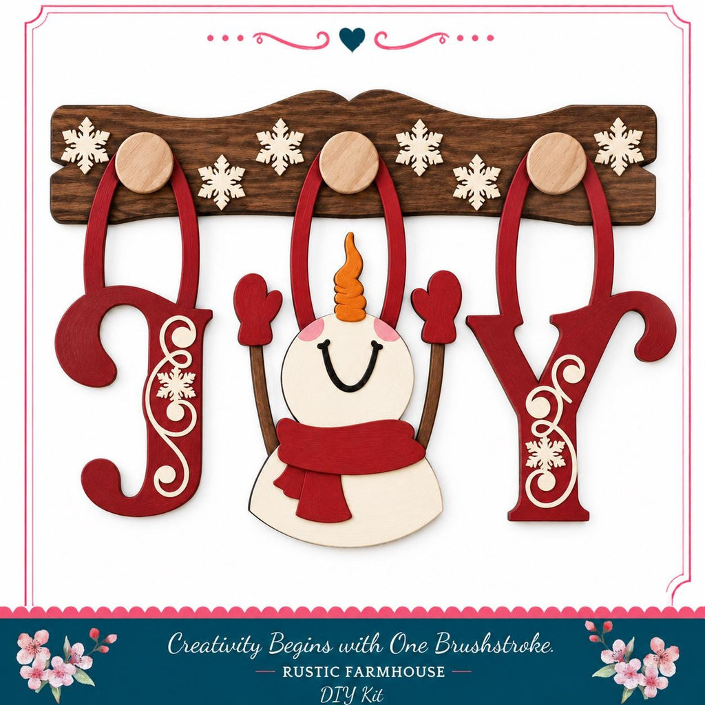 A wooden snowman with a red scarf and a red snowflake ornament, along with the word "Joy" made of wooden letters, is displayed on a wooden board.