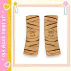 two wooden slats with a smiling face design on them, set against a pink and yellow background with decorative elements.