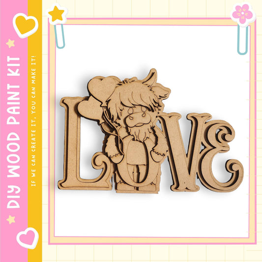 A wooden cutout of a cartoon character with a heart-shaped nose and a heart-shaped ear, set against a pink and yellow background with the text "My Wood Paint Kit" and "If we can create it, you can make it"