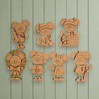A collection of six wooden mouse figurines, each with unique features and accessories, displayed against a light green background.