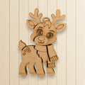 A wooden ornament depicting a cartoon reindeer with antlers and a scarf.