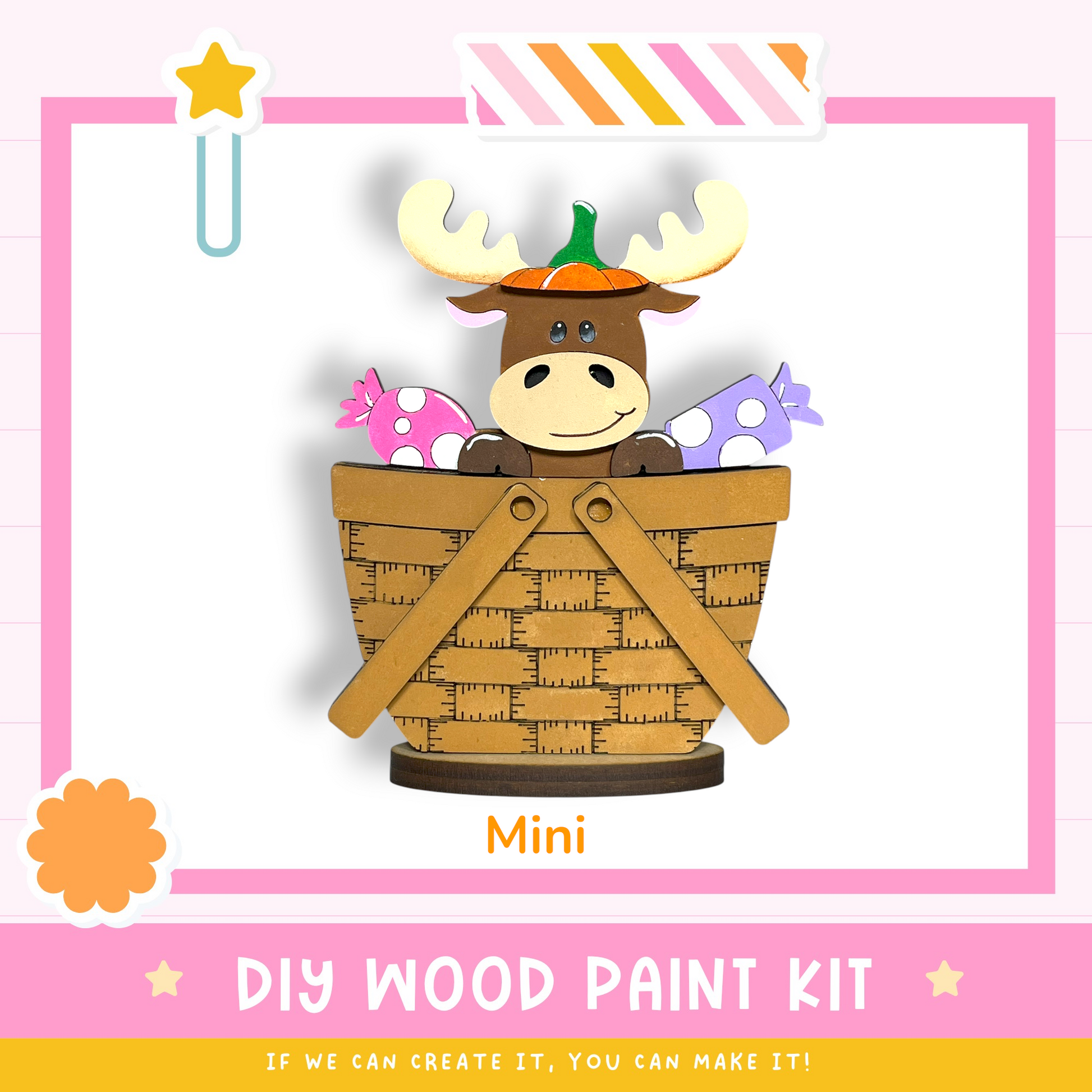 a wooden toy moose sitting in a basket, with a DIY wood paint kit labeled "Mini" and a star decoration.