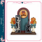 a colorful and festive Thanksgiving-themed display, including a wooden door, a lantern, and various autumn-themed decorations such as pumpkins and leaves.