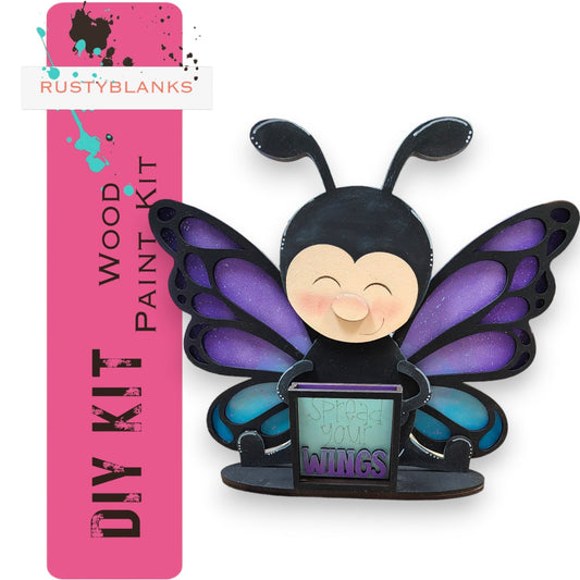 a purple and black butterfly figurine sitting on top of a desk