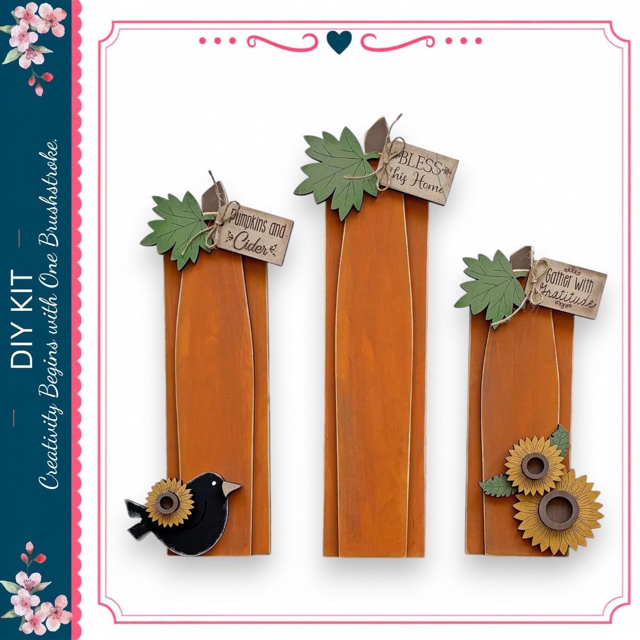 three wooden planks with various decorative elements attached to them, including leaves, flowers, and a bird.
