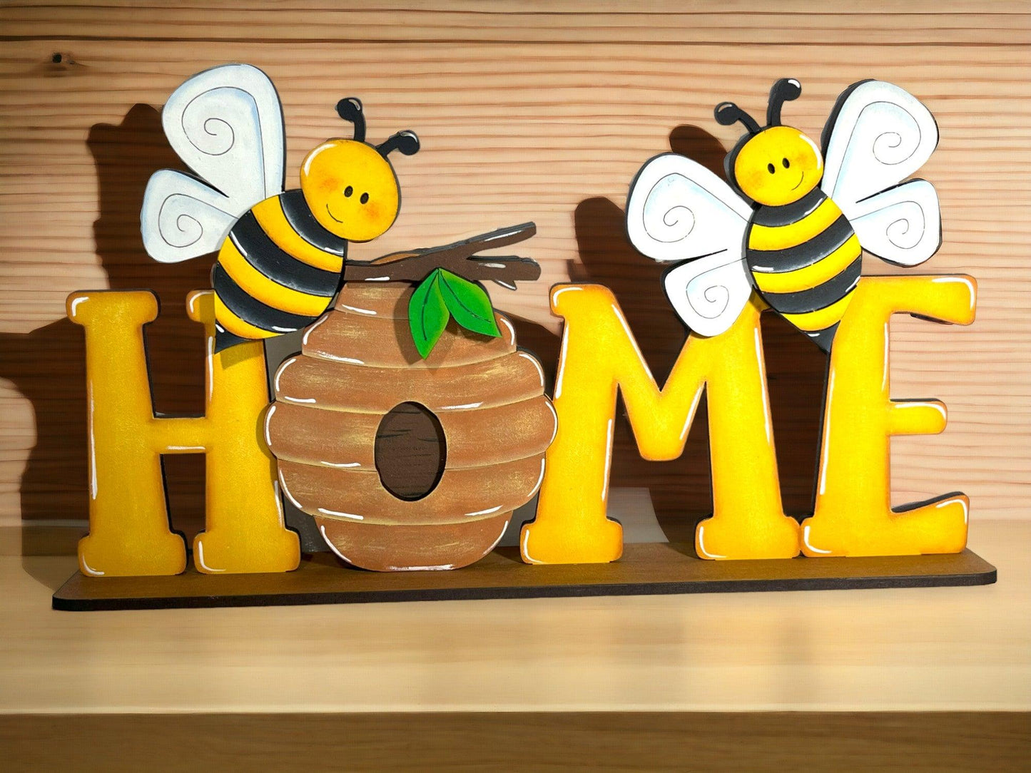 a couple of bees sitting on top of a wooden sign