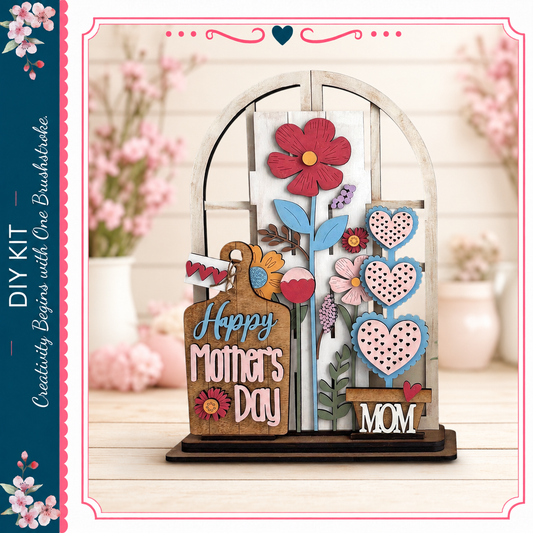 A wooden display with a floral design and the text "Happy Mother's Day" on it, placed on a wooden surface.
