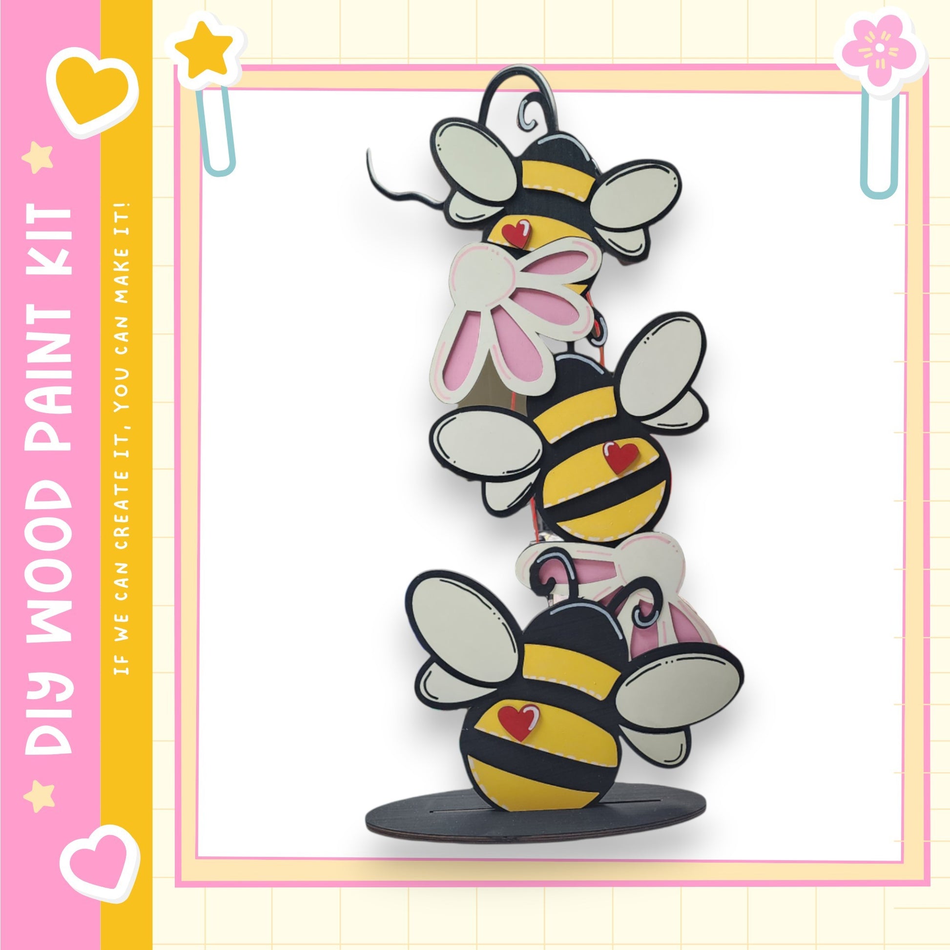 A colorful and whimsical painting kit featuring a playful arrangement of cartoon-style bees on a wooden base.