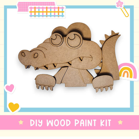 a wooden cutout of a crocodile with a rainbow in the background