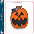 a carved pumpkin with a carved face and the word "BOO" written on it.
