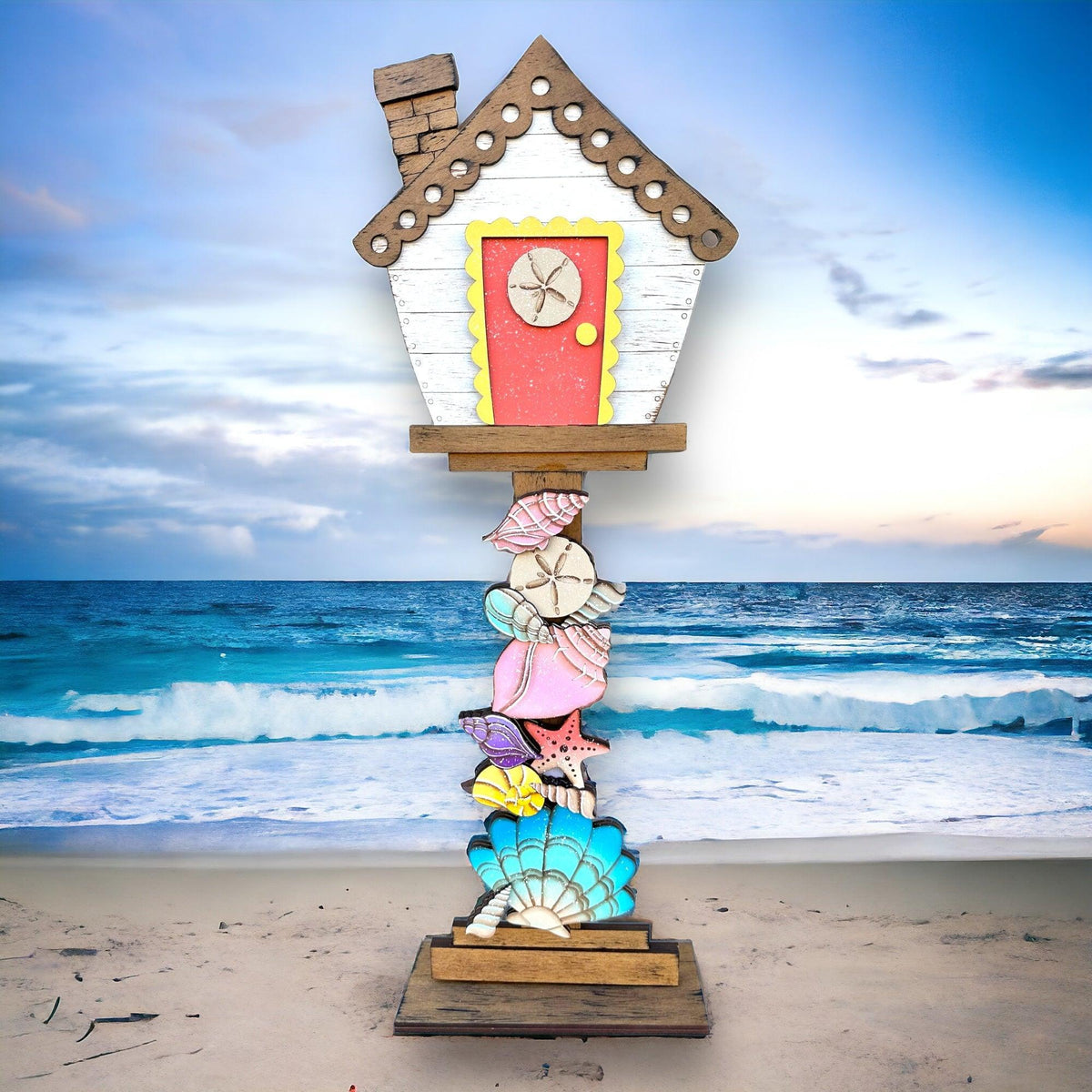 a clock made out of seashells on a beach