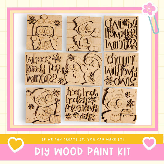 The image is a collage of nine wooden cutouts featuring various winter-themed designs, including owls, snowflakes, and text. The collage is framed with a pink border and includes the text "DIY WOOD PAINT KIT" and "If we can create it, you can make it!"