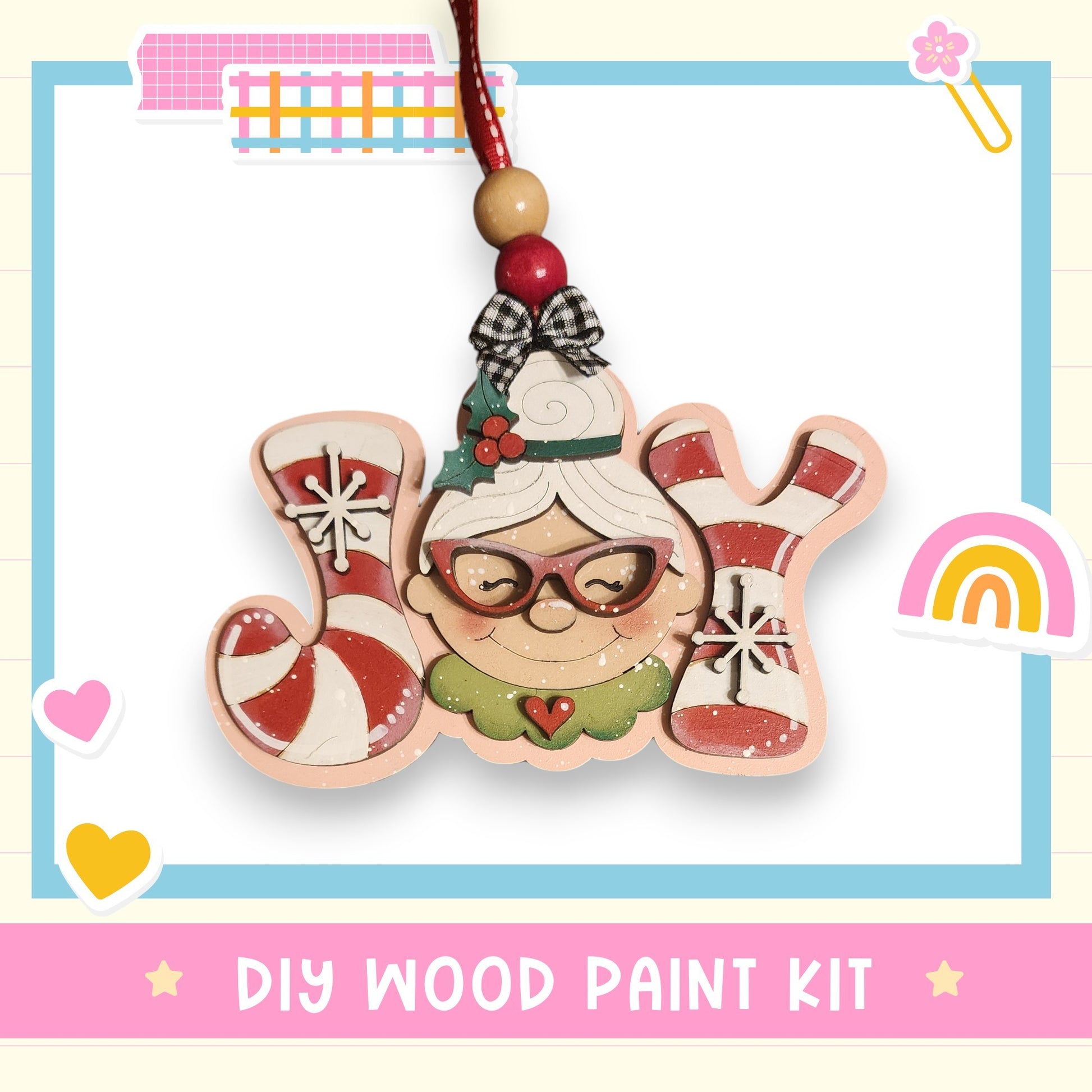 a DIY wood paint kit for creating a wooden ornament with a smiling face and candy cane decorations.