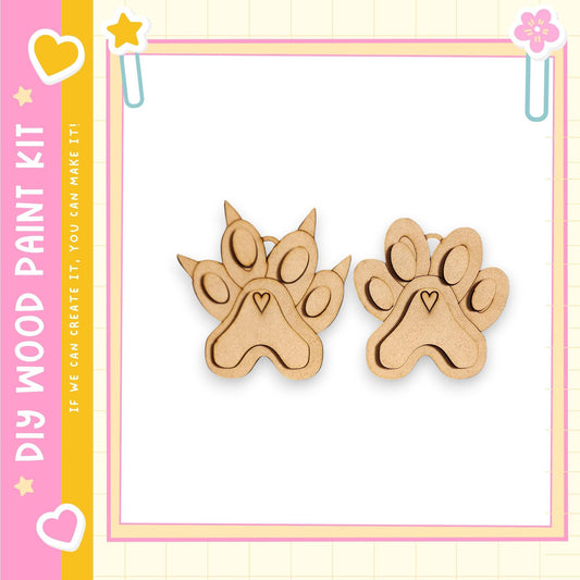 two wooden paw print-shaped objects, which appear to be part of a DIY paint kit.