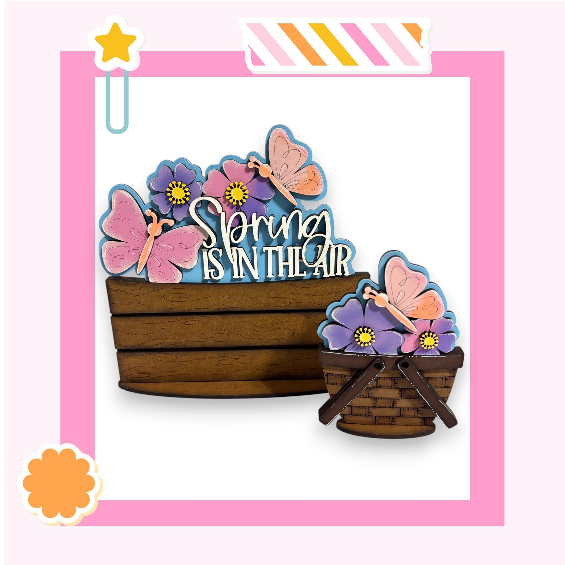 A wooden basket filled with colorful flowers and butterflies, with the text "Spring is in the air" written on it.