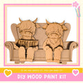 two wooden cow figurines sitting on a couch, with a sign that says "ARM & LIFT" in front of them.