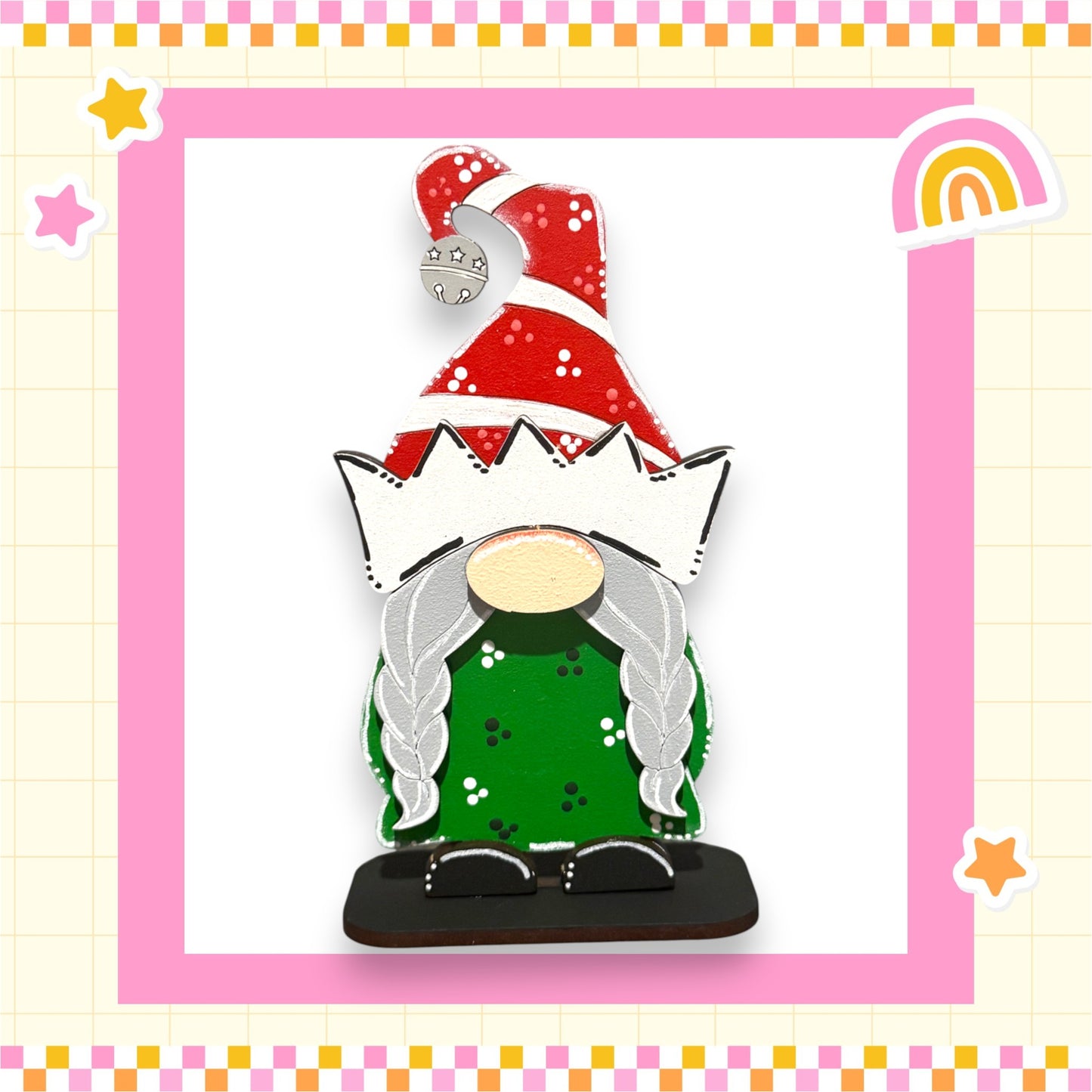 A colorful Christmas ornament in the shape of a gnome, wearing a red and white hat with a bell, green shirt, and gray hair.