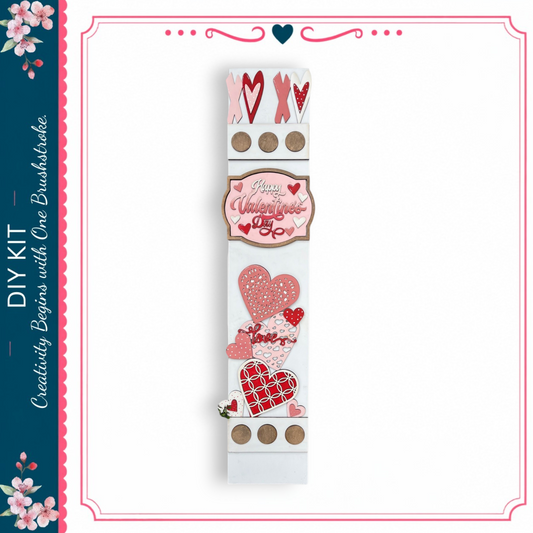 a white sign with various heart-shaped decorations and text, including the words "Happy Valentine's Day" and "DIY Kit".