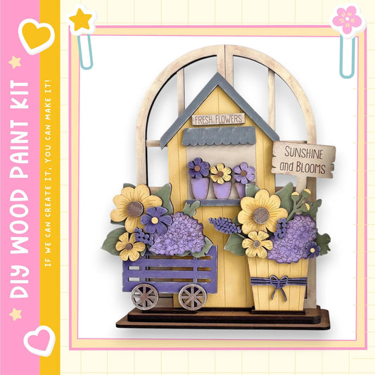 A wooden flower shop with a sign that says "Fresh Flowers" and "Sunshine and Blooms". The shop is decorated with various flowers, including sunflowers, lavender, and purple hydrangeas. The shop is set up in a wooden cart, and there is a sign that reads "Fresh Flowers" above the cart.