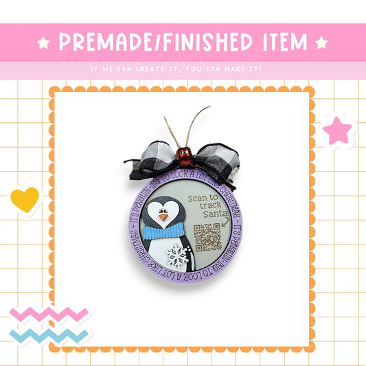 a picture of a penguin ornament hanging on a wall