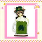 a green mug with a stuffed animal in it