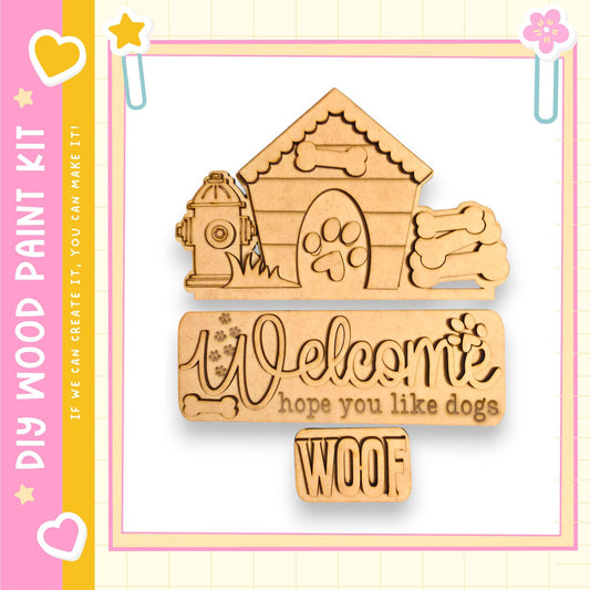 a wooden sign with the text "Welcome hope you like dogs" carved into it, along with a dog house and fire hydrant. The sign is surrounded by a pink and yellow border, and there are small decorative elements such as hearts and flowers on the border.