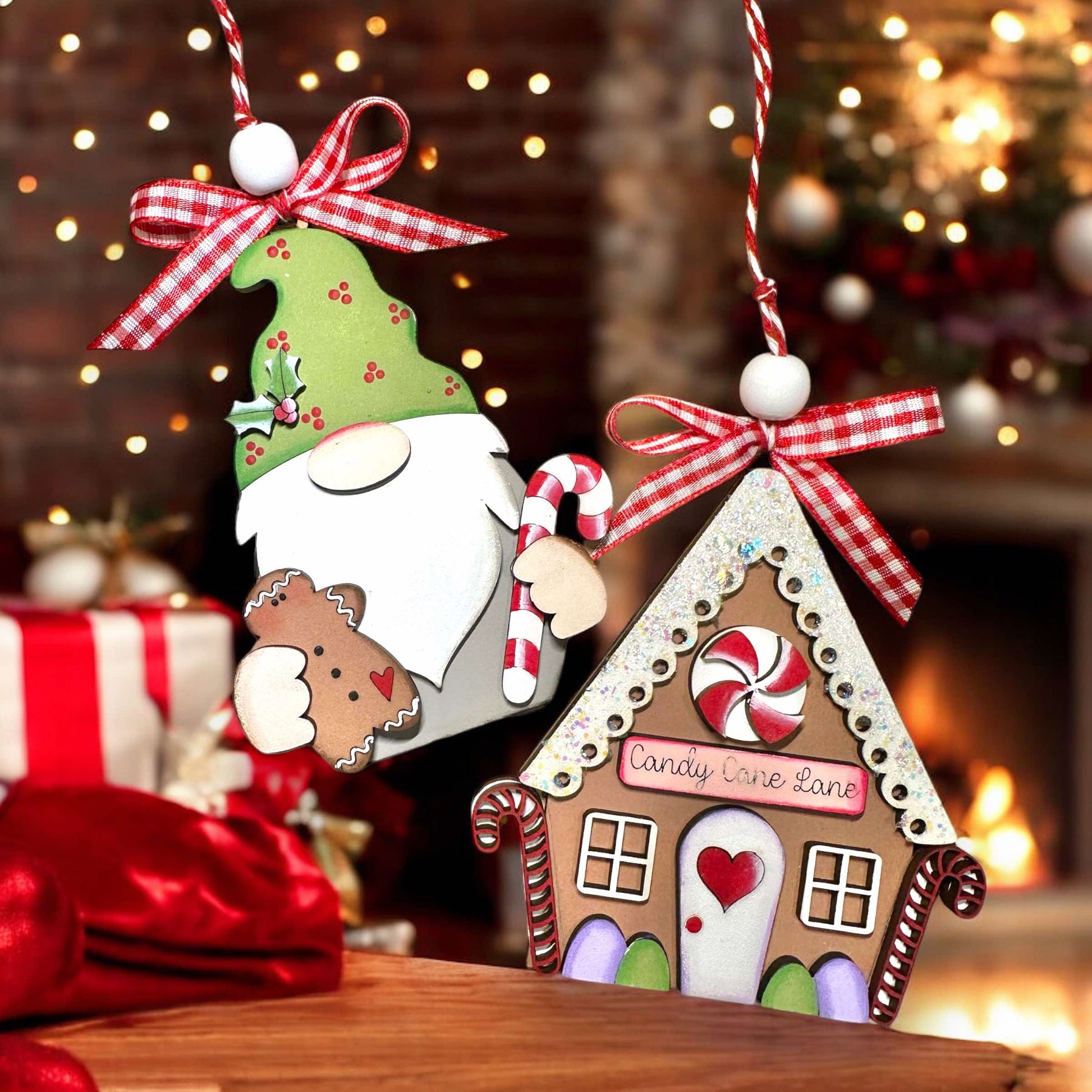 a gingerbread house ornament with a santa clause holding a candy cane