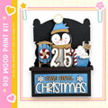 A wooden paint kit with a penguin figure and a sign that says "25 DAYS UNTIL CHRISTMAS".