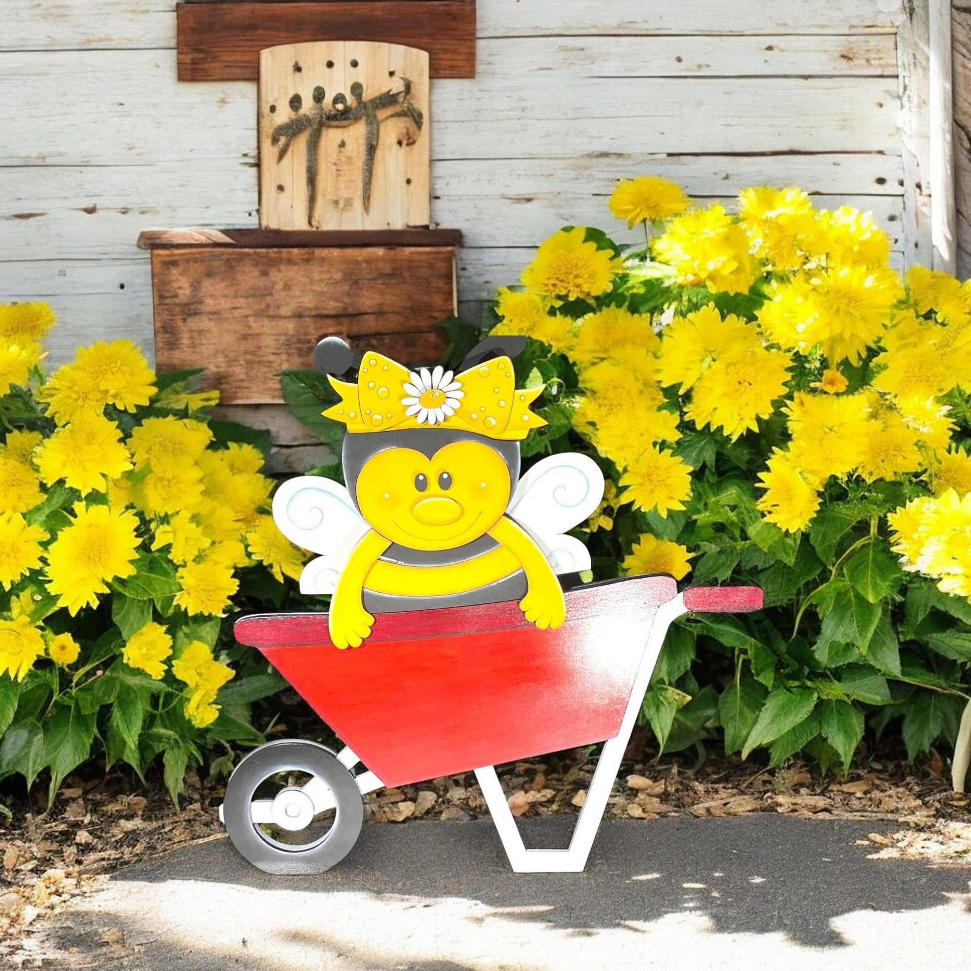 a yellow and white bee sitting on top of a wheelbarrow