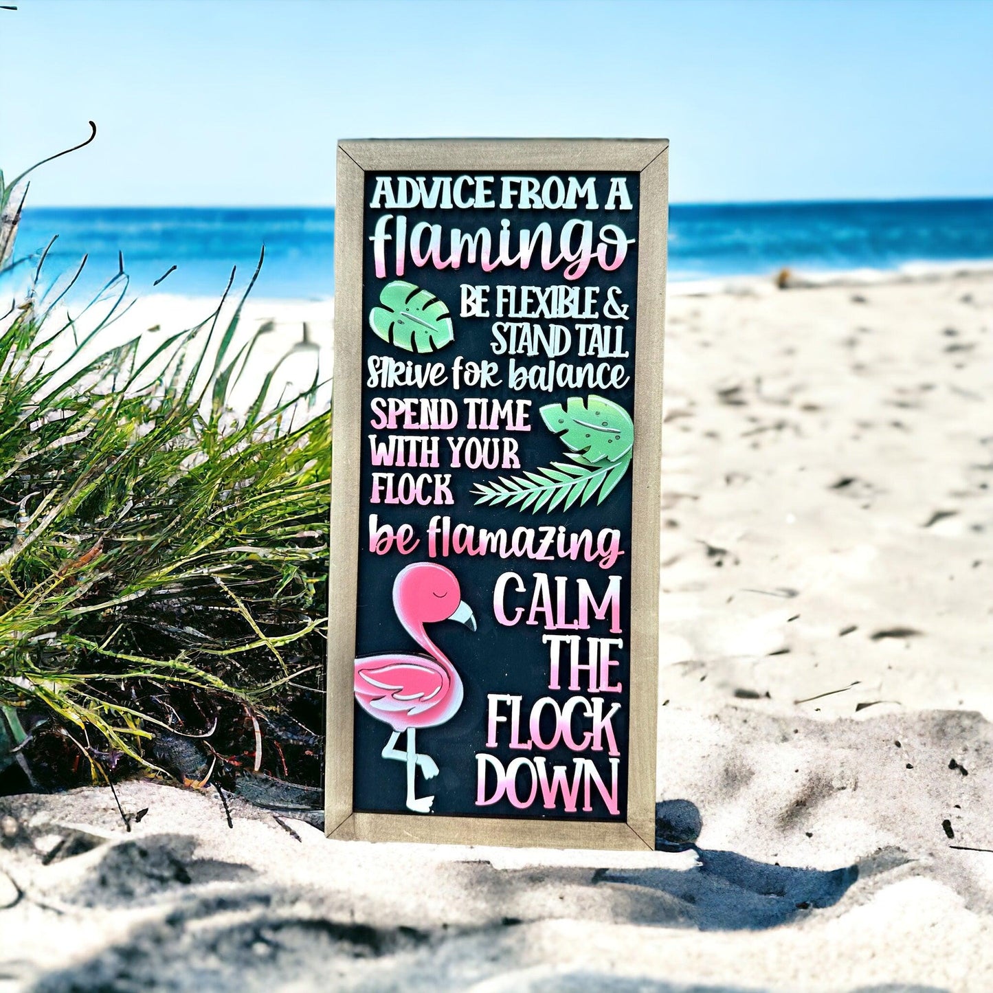 a sign on the beach that says advice from a flamingo