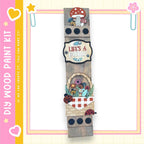 The image is a wooden sign with various decorative elements, including a mushroom, flowers, and ladybugs, mounted on a wooden frame.