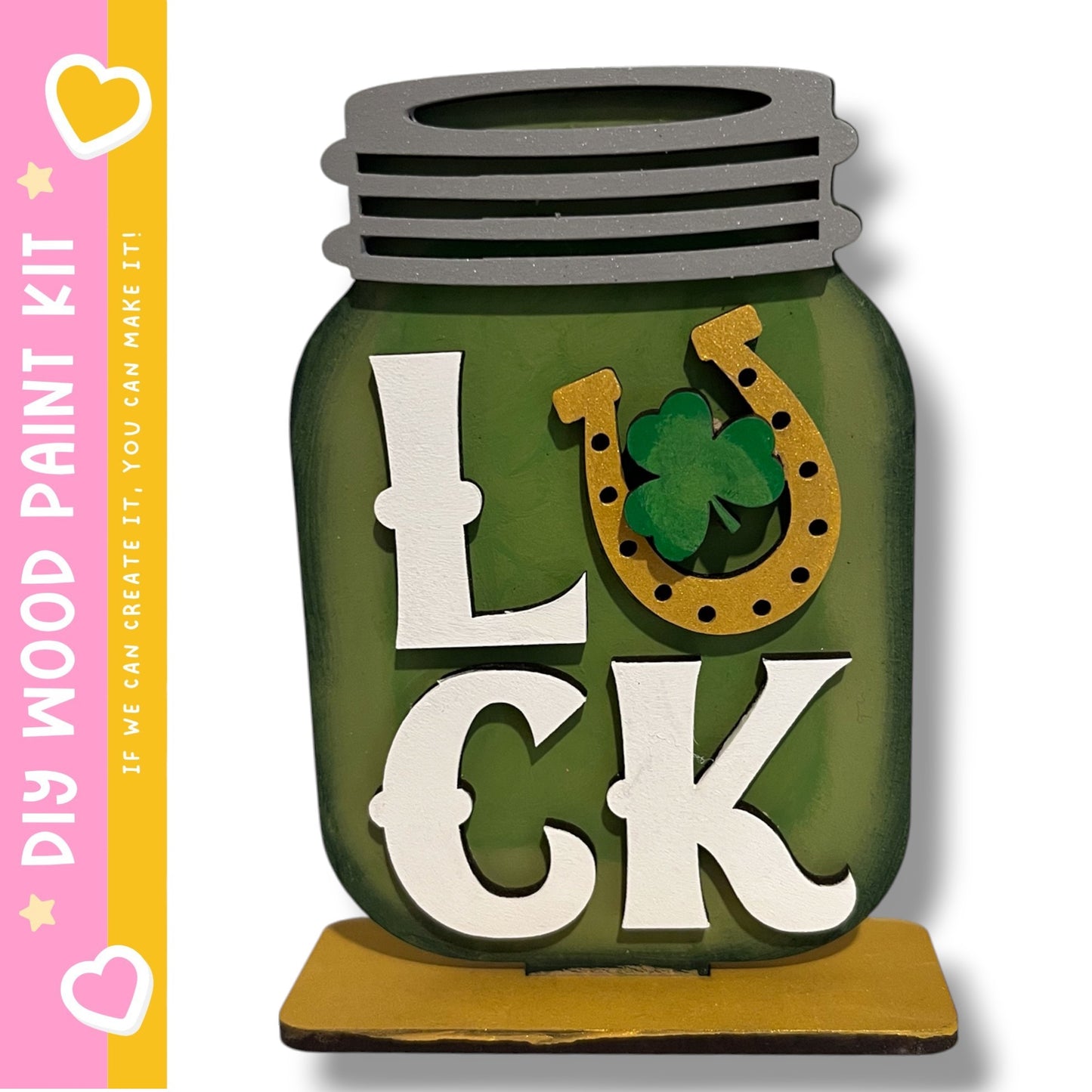 A green glass jar with the word "LUCK" written on it, along with a horseshoe symbol.