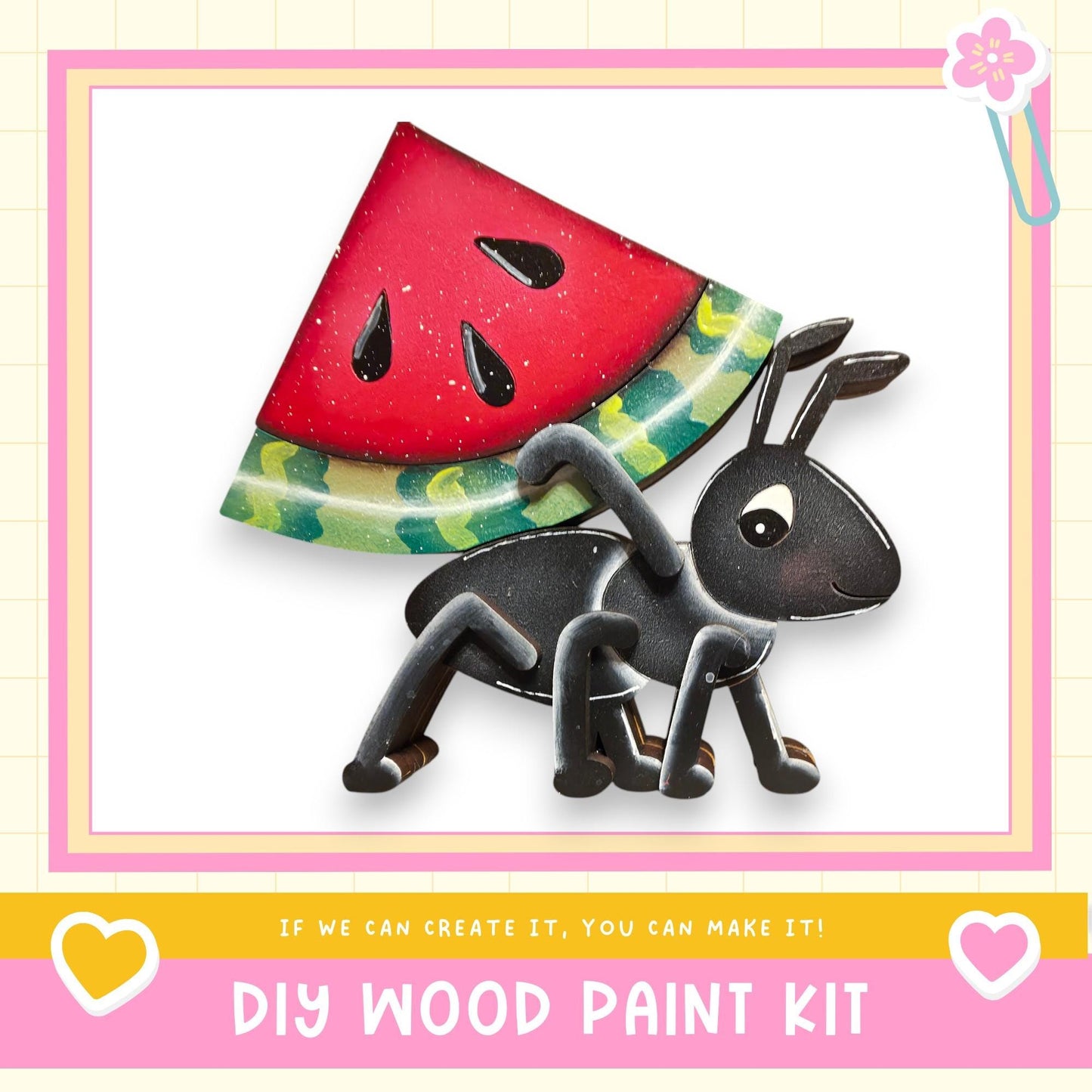 The image is a DIY wood paint kit featuring a black ant carrying a slice of watermelon on its back, set against a pink and yellow background.