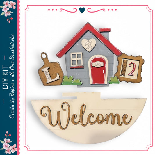 a wooden house with a "Welcome" sign below it, along with various decorative elements such as a heart, a number 2, and a wooden board.