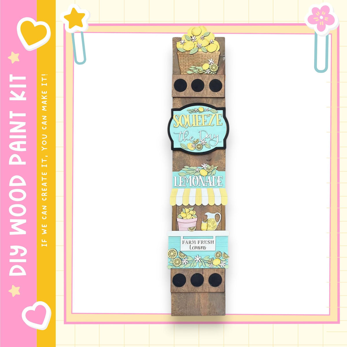 A vertical wooden sign with various illustrations and text, including a lemonade sign, a heart, and other decorative elements, all set against a pink and yellow background.