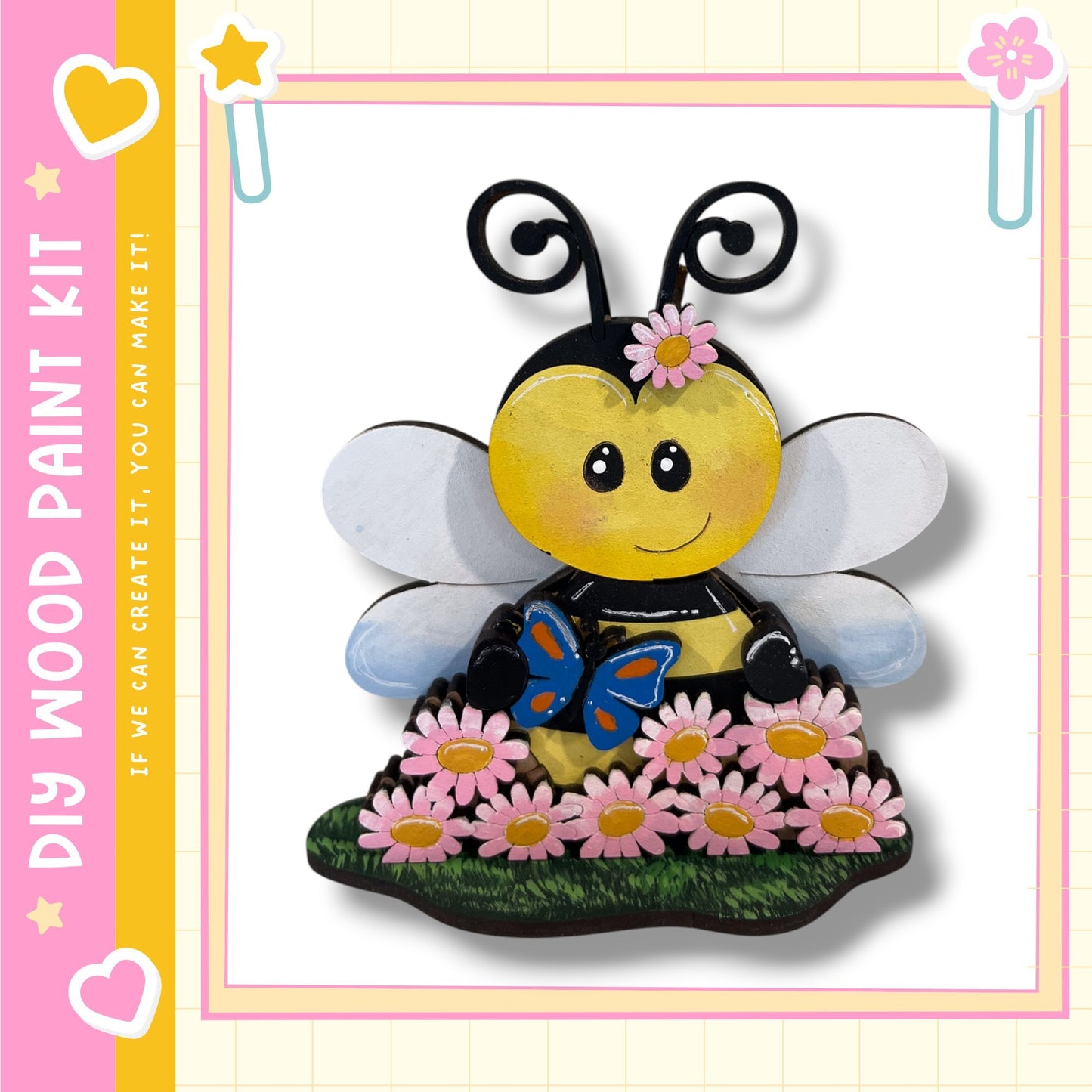A cheerful painted bee with a flower on its head, surrounded by pink flowers, is depicted in the image.