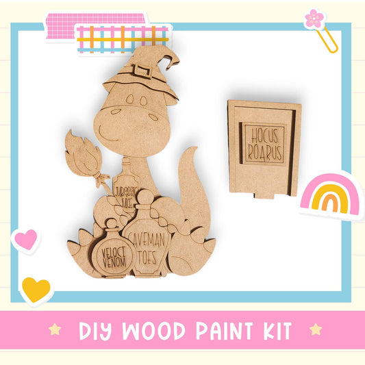 a DIY wood paint kit, including a wooden dinosaur figure and a wooden sign with the text "Hocus Roarus".