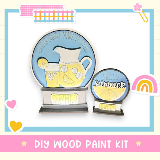 The image is a DIY wood paint kit for creating a summer-themed decoration, featuring a wooden snow globe with a pitcher and lemon slices.