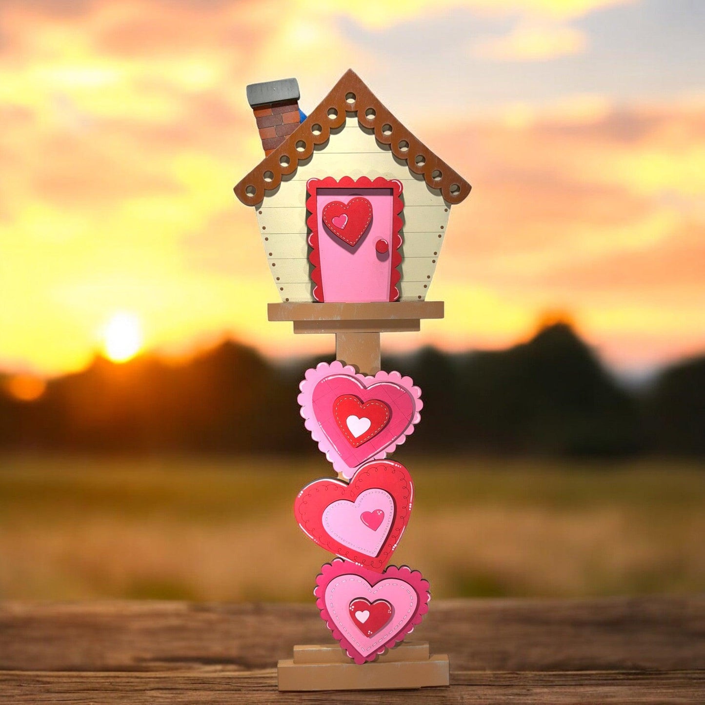 a wooden stand with a house and hearts on it