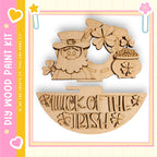 a wooden cutout of a leprechaun holding a pot of gold coins, with the text " Luck of the Irish" below it.