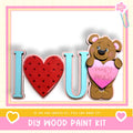 a wooden paint kit with a teddy bear holding a heart-shaped sign that says "I love you".