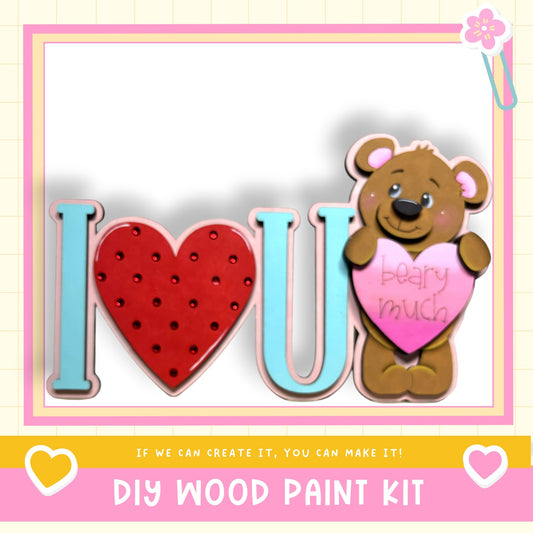 a wooden paint kit with a teddy bear holding a heart-shaped sign that says "I love you".