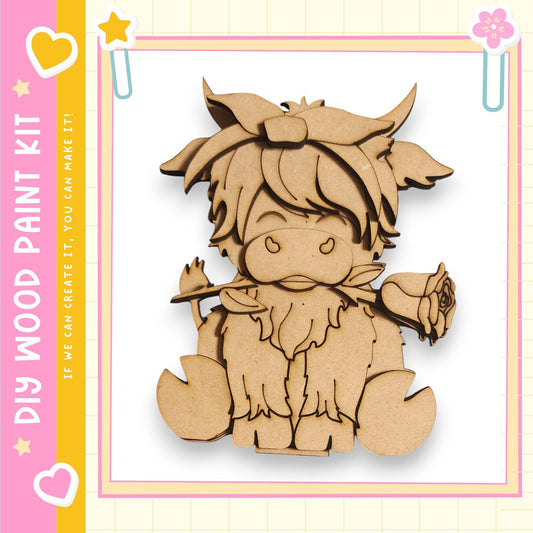 a wooden cutout of a cartoon character, likely a cow or a similar animal, with a flower in its mouth. The character appears to be made of wood and is sitting on its hind legs. The image is framed by a pink border and contains text that reads "My Wood Paint Kit" and "If we can create it, you can make it".